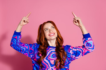 Photo portrait of attractive young woman look point up empty space dressed stylish blue colorful clothes isolated on pink color background