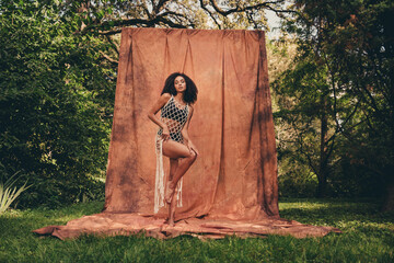 Wall Mural - Photo of lovely stunning lady wearing stylish lace tunic posing exotic garden isolated on brown textile background