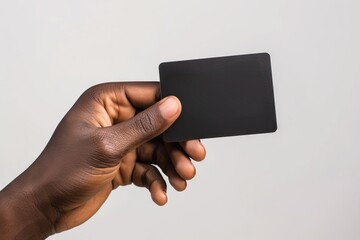 Black male hand holding blank credit card on white background.