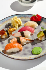 Wall Mural - Elegant Sushi Set on Plate with Salmon, Shrimp, Perch, Tuna, Scallop, and Eel - Minimalistic and Bright