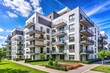 © Sathaporn Buarabut - Modern residential complex with white and grey apartment buildings with balconies