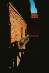 inside of a castle, brick wall with a bridge