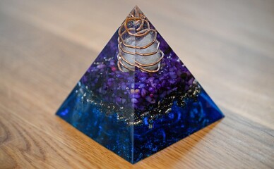 High resolution image of a single isolated beautiful one of a kind hand made Orgone pyramid generator containing crystals