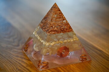 High resolution image of a single isolated beautiful one of a kind hand made Orgone pyramid generator containing crystals