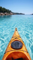 Poster - A bright orange kayak glides over turquoise water, reflecting sunlight as it moves calmly along a serene seaside landscape under a clear blue sky