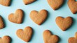 © GenZGraphics - Heart shaped homemade gingerbread cookies displayed against a blue backdrop