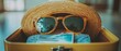 © Hryhor Denys - A suitcase is packed with a straw hat, sunglasses, casual shorts, and a postcard hinting at a beach trip, ready for a sunny vacation