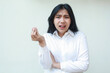 © M Alfan Setyawan - image of stress asian woman arguing with boss pose, look at camera asking gesture with raising hands and folded arm, wearing formal shirt standing over isolated background