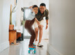 © Abrahams/peopleimages.com - Father, child and skateboard learning in home with boy, smile and game together with care. Support, love and balance with growth, development and fun with teaching and African family with joy