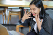 © M Alfan Setyawan - surprised asian woman using laptop in cafe doing virtual job interview looks grateful and delighted, feeling glad