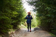© Xalanx - Woman in rain jacket on a hiking trail