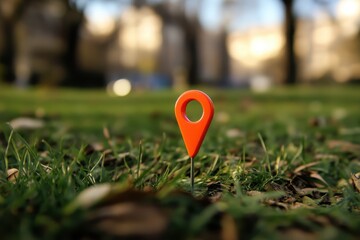 red map pin in grass outdoors