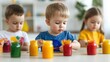 © GreenMOM - Three young children engaged in creative painting with colorful jars, promoting fun and artistic expression in a bright setting.