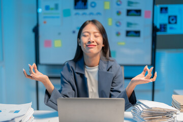 Businesswoman is finding her zen with meditation at her desk, promoting mental wellness and stress relief in the workplace