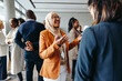 © Jacob Lund - Smiling Muslim businesswoman sharing and talking during a networking event