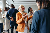 Smiling Muslim businesswoman sharing and talking during a networking event