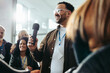 © Jacob Lund - Enthusiastic participant engaging in questions and answers session at a seminar, fostering communication and achieving success