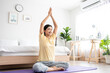 © Kawee - Asian young beautiful sportswoman doing yoga pilates workout at home.