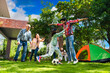 © StockImageFactory - Indian family of six happily playing a blindfold game during a camping trip, creating memories