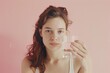 © Vii - A woman holds a glass of water up to shield her face from the sun