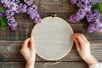 A woman holding a white embroidery on a wooden surface