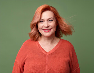 Wall Mural - Studio Portrait of Mature Teacher Woman Happily Smiling Against Colored Studio Background