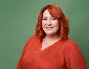 Wall Mural - Studio Portrait of Mature Teacher Woman Happily Smiling Against Colored Studio Background