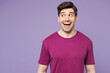 © ViDi Studio - Young shocked surprised excited Caucasian man he wearing violet t-shirt casual clothes look aside on area mock up isolated on plain pastel light purple background studio portrait. Lifestyle concept.