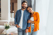 © Maria Vitkovska - Portrait of positive happy Hispanic couple wearing colorful clothes looking at camera, fashion model