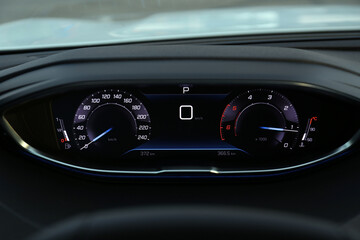 Speedometer on dashboard inside of modern luxury car, closeup