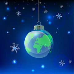 Sustainability concept with a globe christmas ornament hanging in a night snowy sky