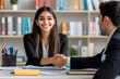 © GustavsMD - Cheerful Indian student woman talking to male professor in college library, giving handshake to tutor, teacher, thanking for help in study research