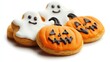 © Ti Studio - Halloween-themed cookies shaped like pumpkins and ghosts, decorated with icing, isolated on white background