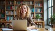 © Thierry - Bright student researching in a quiet library — A smiling young woman with curly hair researching on her laptop, surrounded by books in a calm library.