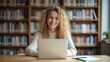© Thierry - Woman studying happily in a peaceful library — A young woman smiling as she works on her laptop in a library, enjoying a calm and focused study environment.