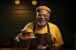 © Rawpixel.com - African American grandfather food holding burger.
