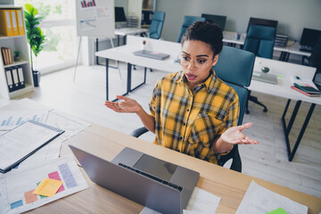 Photo of attractive young woman scared video call working wear yellow plaid shirt comfortable modern office room interior indoors workspace