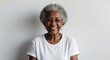 © Arceli - mixed race elderly woman white background wearing plain white tshirt smiling happy portrait