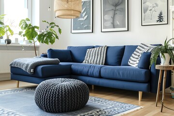 Living room interior design with two knitted poufs near dark blue corner sofa