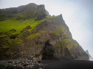 Wall Mural - Scenic view of Halsanefshellir Cave on Reynisfjara Black Sand Beach, against the sky in Iceland