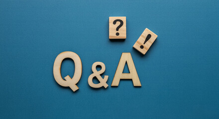 Poster - Wooden Q&A letters and symbols on blue background representing business and inquiry