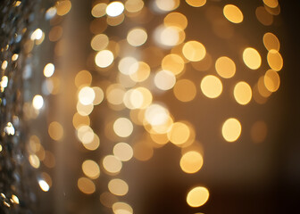 Aufkleber - Glittery vintage lights shine against an abstract background in a mix of silver, gold, and white colors with blurred effect.