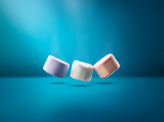 Poster - Three marshmallows, purple, white, and peach, are floating against a turquoise blue background.
