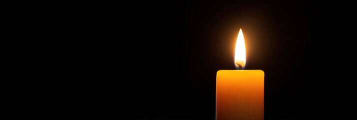 Poster - single candle glowing softly in dark room creates serene atmosphere