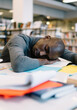 © BullRun - Peaceful African American man falling asleep while studying