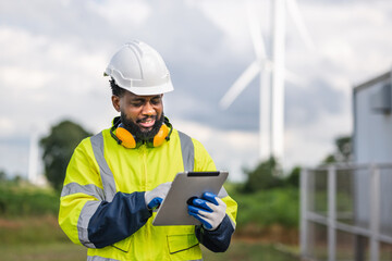 man in a yellow and black safety vest is looking at a tablet