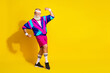 © deagreez - Full length photo of sportive cool modern pensioner dressed vintage jacket showing muscles emtpy space isolated yellow color background