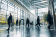 © Rattanapon - Blurred business people walking in the lobby of a modern office building.