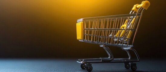 A small shopping cart on a dark background with a warm light behind it.