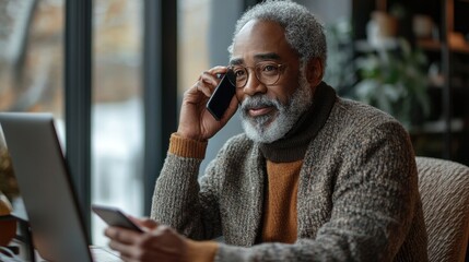 Poster - A man is talking on his cell phone while sitting at a desk